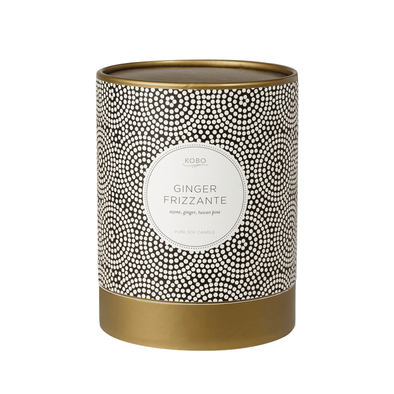 Front view of Ginger Frizzante Coterie 11 oz pure soy candle showcasing its black and white dotted vessel and gold base