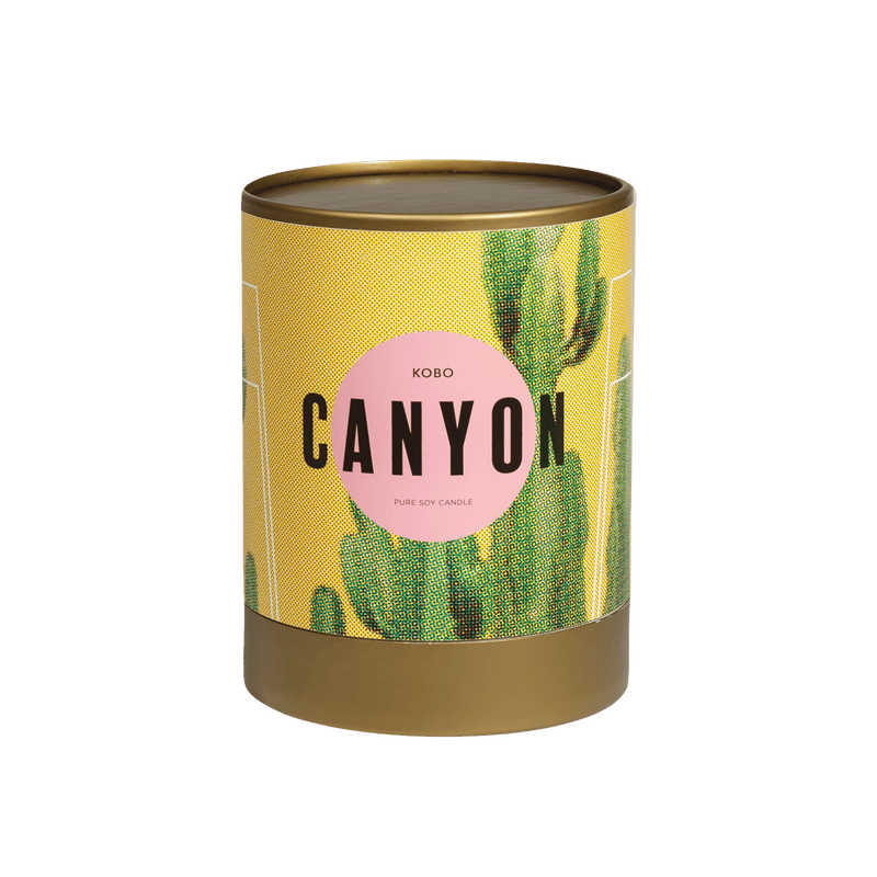 Front view of Canyon Road Trip Candle showcasing a yellow and green cactus-patterned tin with a transparent background
