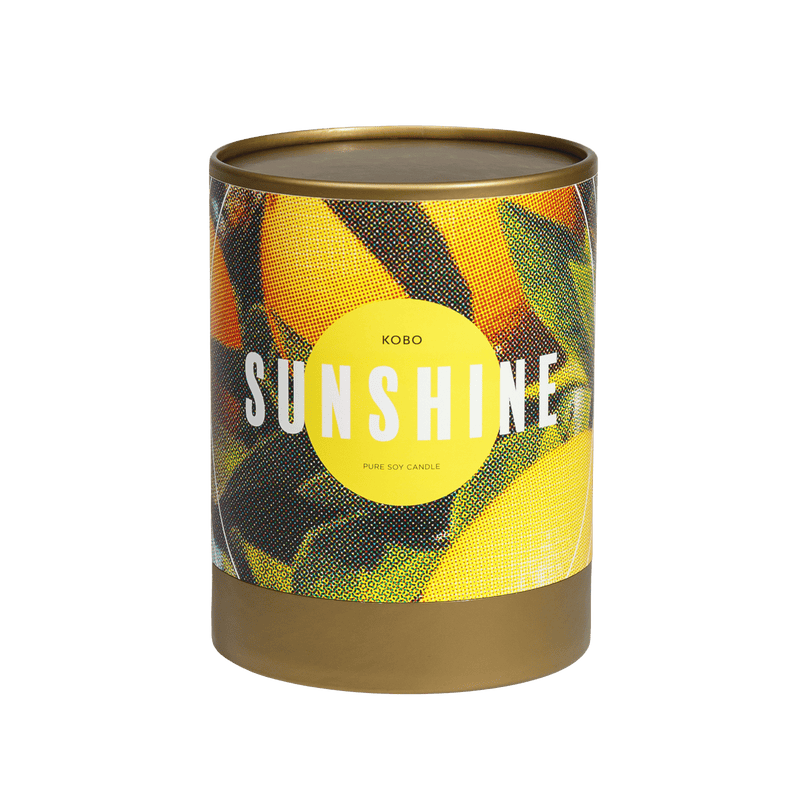 Front view of Sunshine Road Trip Candle showcasing its colorful geometric SUNSHINE label on a brown vessel