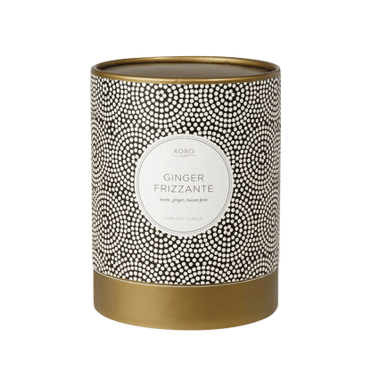 Front view of Ginger Frizzante Coterie 11 oz pure soy candle showcasing its black and white dotted vessel and gold base