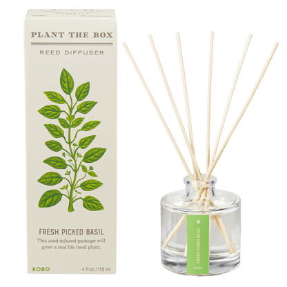 Front view of Fresh Picked Basil Plant the Box Reed Diffuser showcasing clear bottle, reeds, and illustrated basil box
