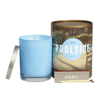 Front view of Poolside Road Trip 11 oz Pure Soy Candle showcasing a blue glass vessel, patterned tin, and matches