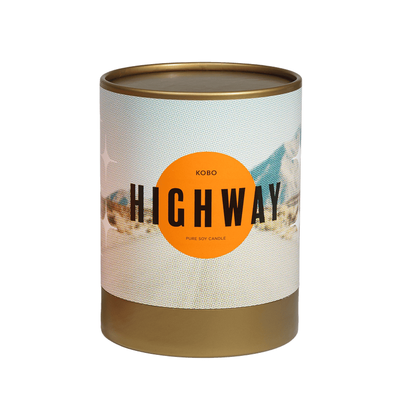 Front view of Highway Road Trip Candle showcasing its highway themed label and pure soy candle text on a transparent background